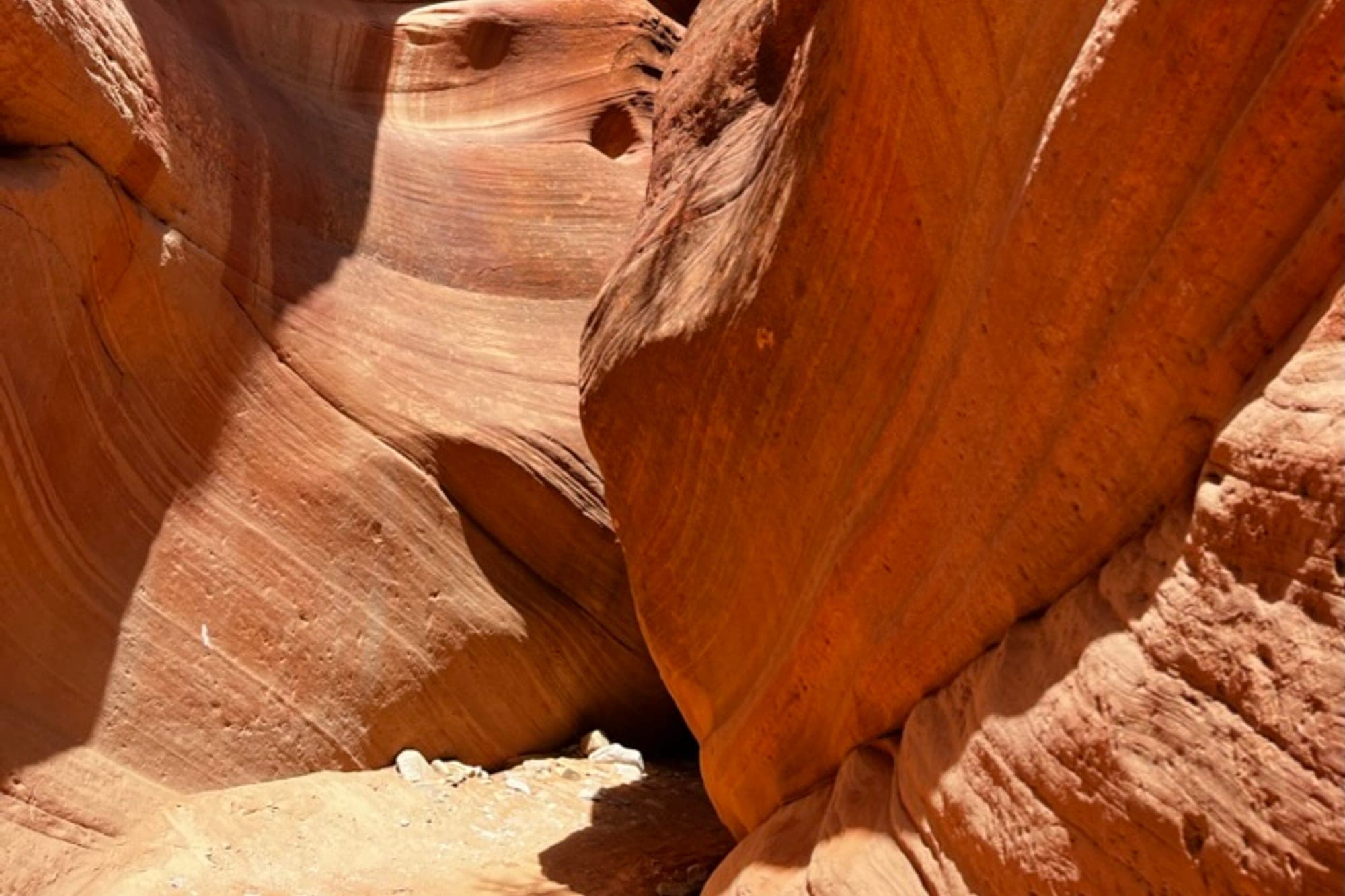 A narrow sandstone slot canyon lit by reflected desert light