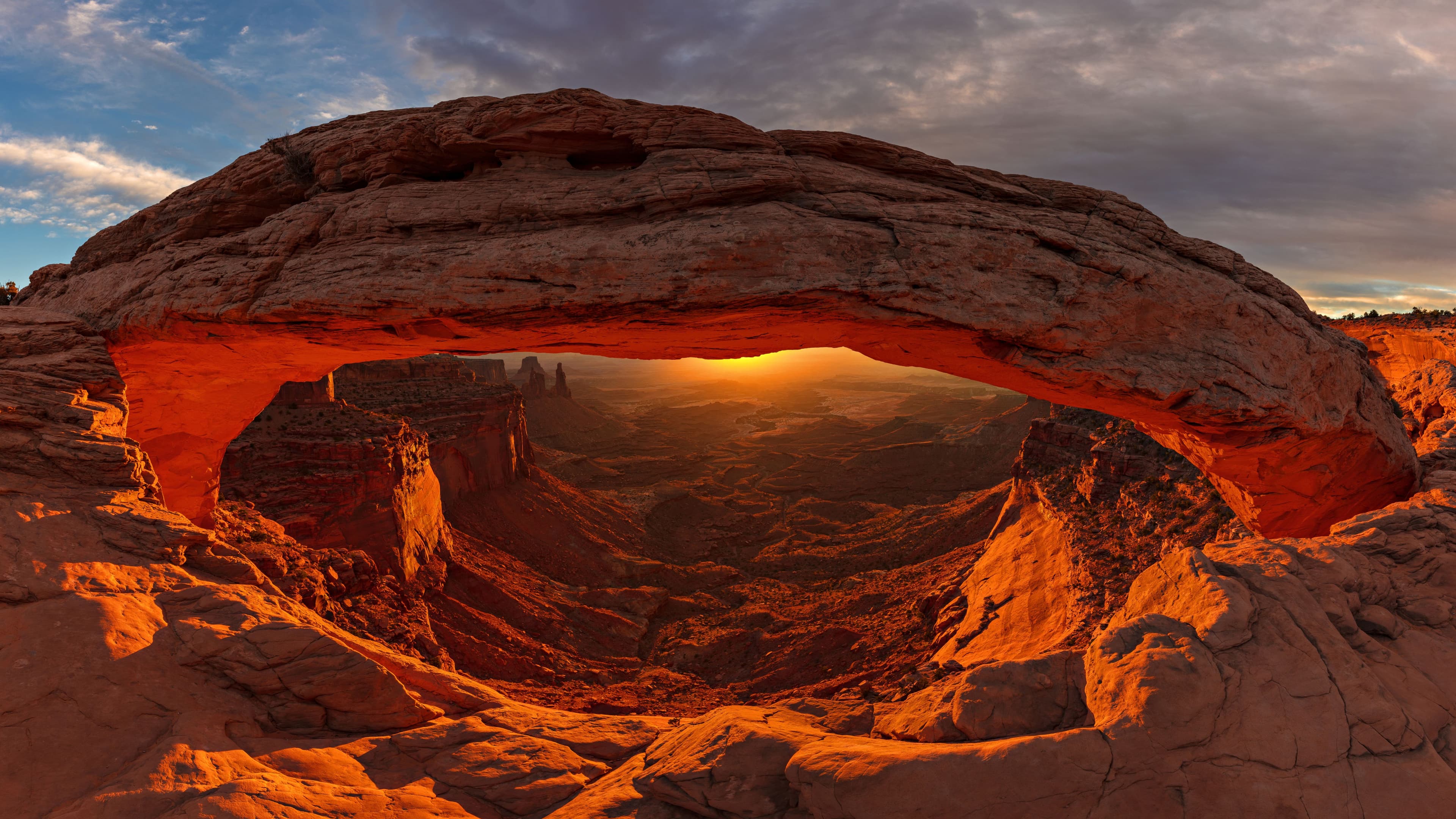 Sunset light beneath a sandstone arch in a national park