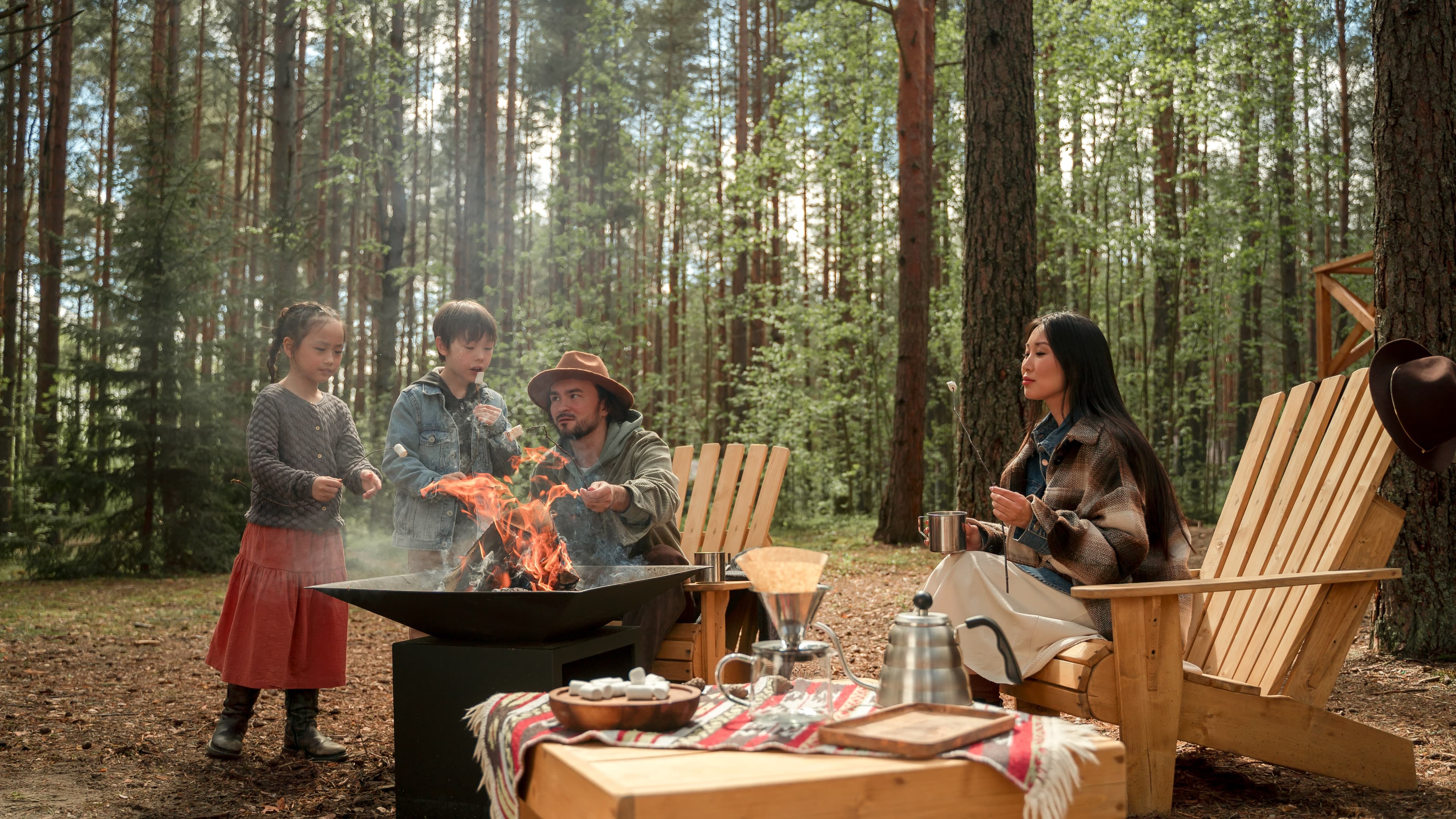 A family setting up camp together at a developed campground