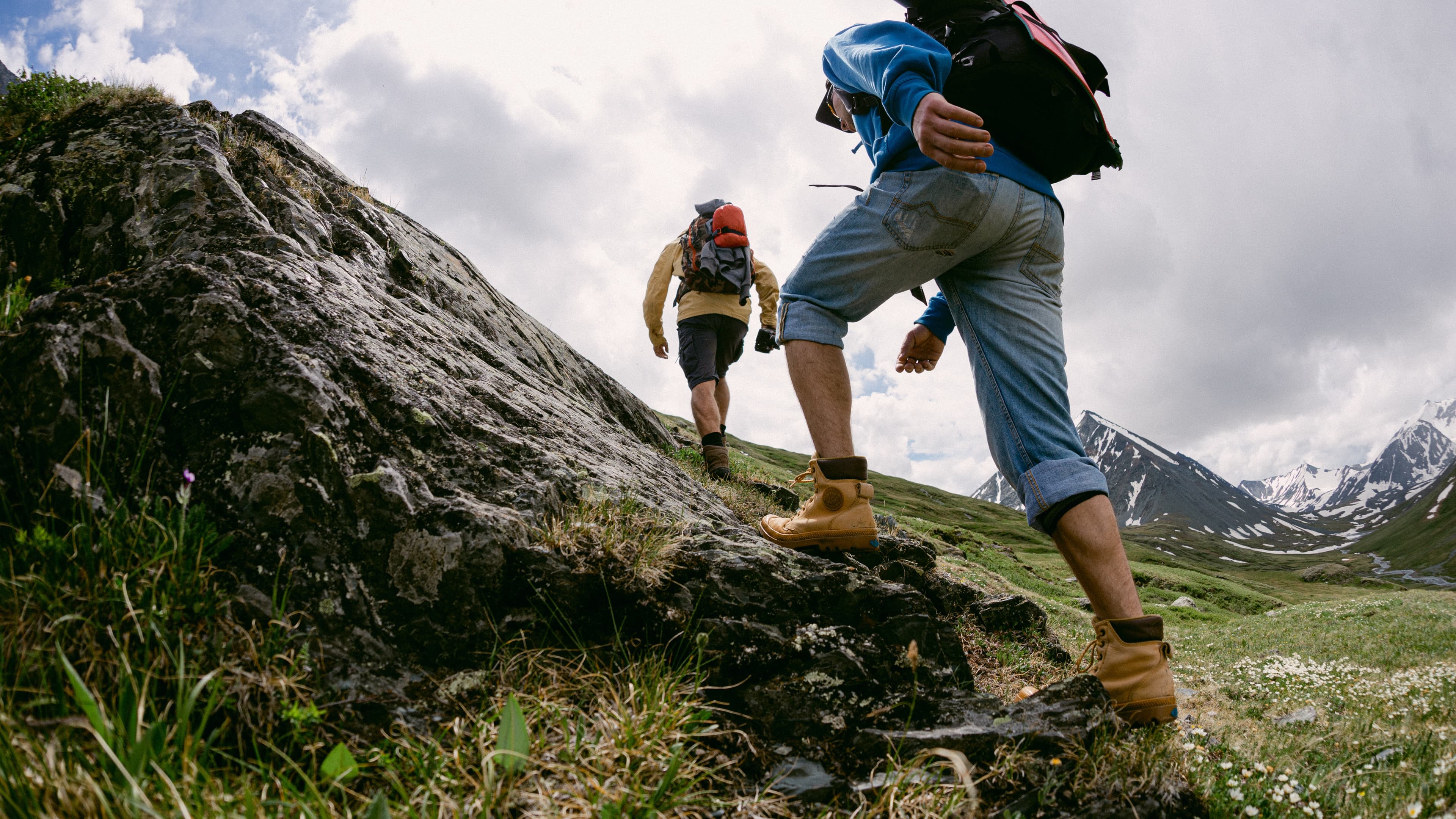 Beginner backpacker carrying a loaded pack on a mountain trail during a first multi day backpacking trip