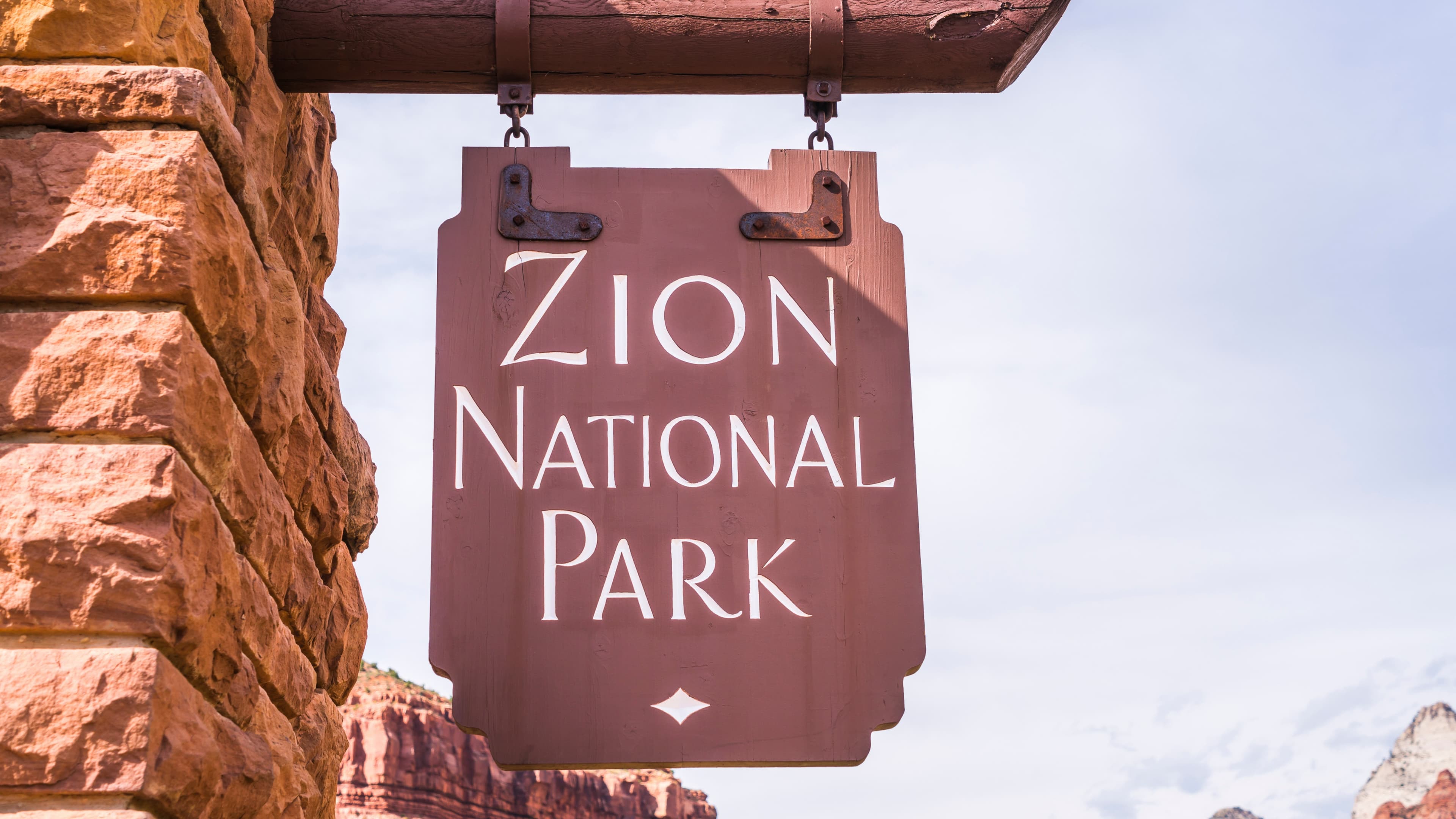 A hiking trail winding through Zion National Park's sandstone canyon walls